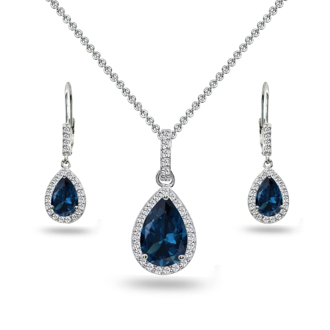 925 sterling silver London blue topaz teardrop halo necklace and earrings set on cream background