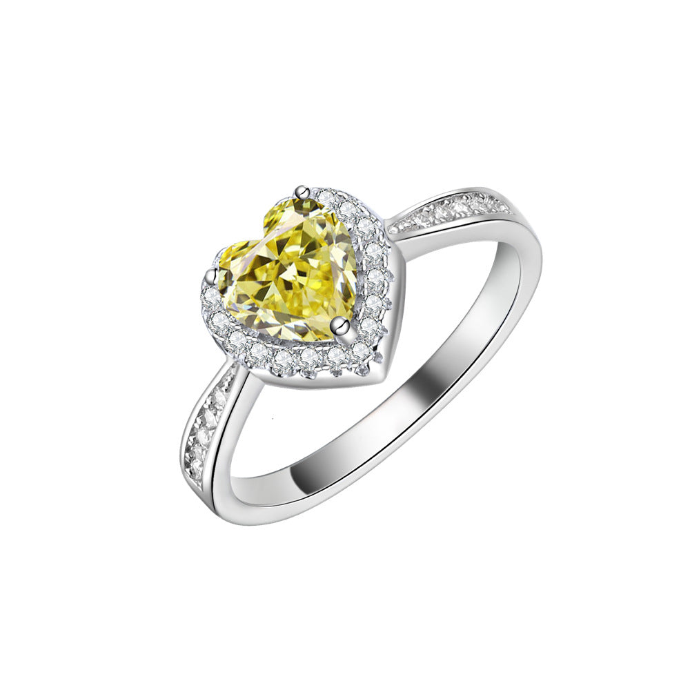 Heart halo ring in 925 sterling silver with a yellow cubic zirconia centre and pave shoulders