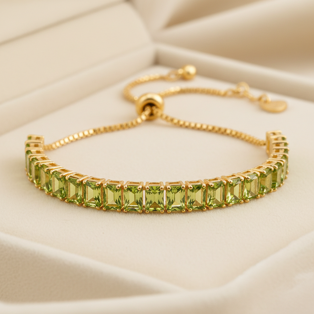14K gold plated August birthstone baguette bracelet with peridot CZ stones on cream background