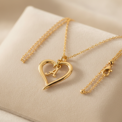 14K gold plated initial heart necklace with dainty letter charm on cream background