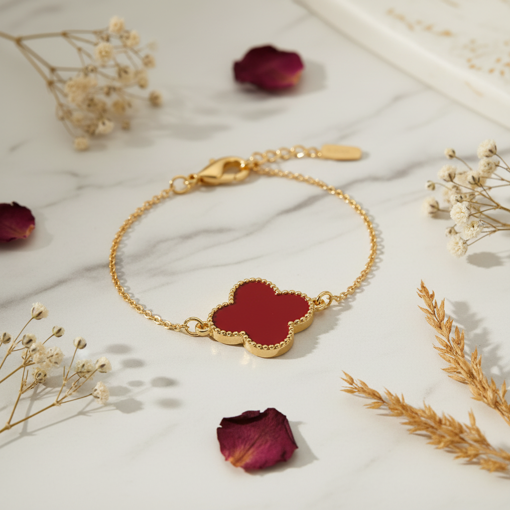 Lucky Four Leaf Clover Charm Bracelet flat lay on white marble with dried flowers